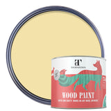 A can of Thorndown wood paint in front of a large circular color swatch showing the paint color, which is a pale warm yellow. The can features a red and white label with a green stylized dog logo.